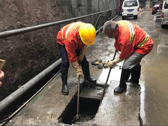 下水道排管被粪便堵塞臭水四溢 市政工人冒雨疏通3小时