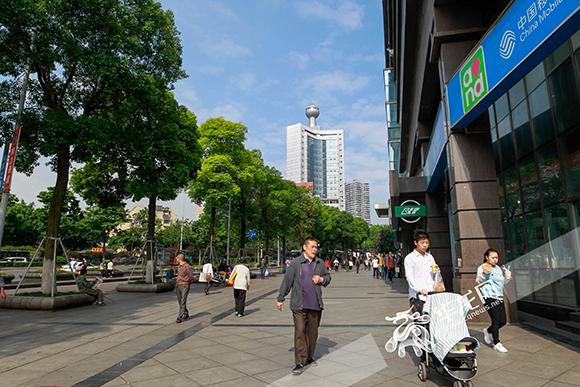 两路口,天空蔚蓝,市民在街头散步. 记者 王峥 摄