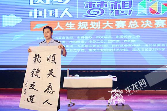 来自渝中区的杨东旭现场表演书法.记者 李裕锟 摄