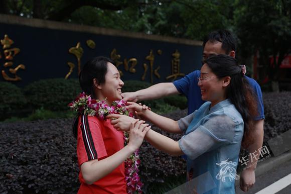 高考结束,重庆一中,家长给刚走出考场的孩子戴上花环. 记者 谢鹏 摄