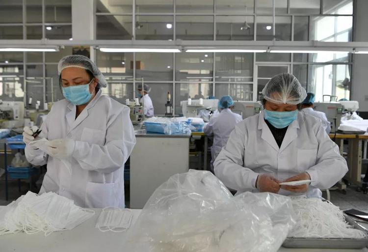 2月7日,在制鞋企业莆田双联鞋业有限公司的生产车间,工人在清理口罩上